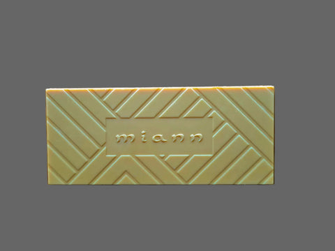 Caramel Chocolate bar with 'miann' branding on a wooden surface